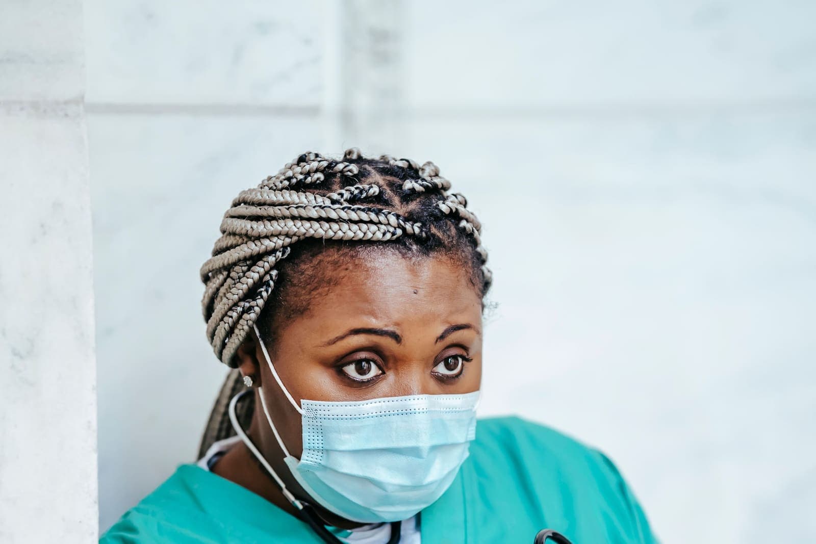 Nurse in scrubs reviewing records on a tablet